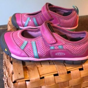 Hot pink and teal Keen all weather shoes.
